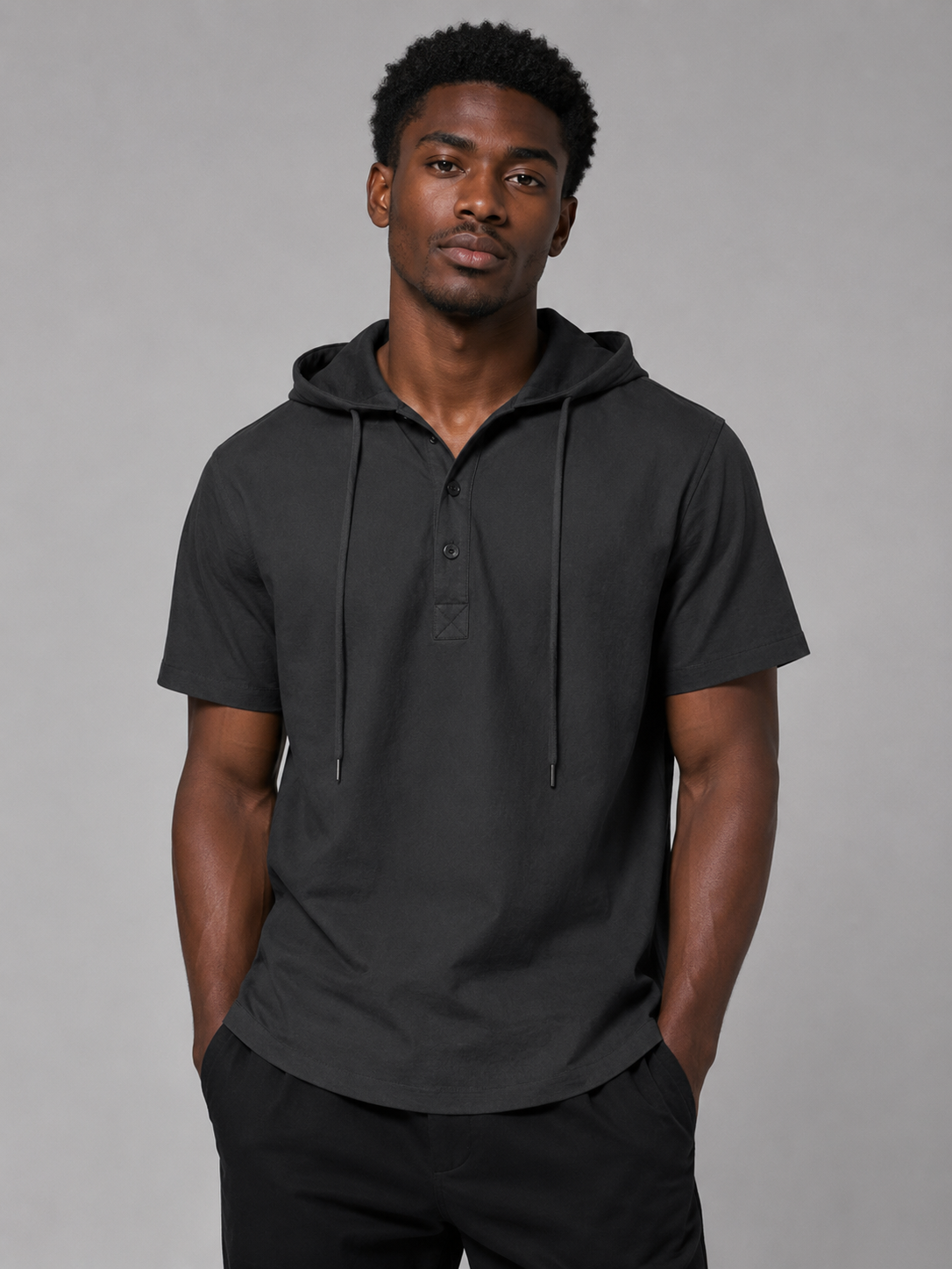 Black short-sleeve hooded Coastline shirt styled on a male model, front view