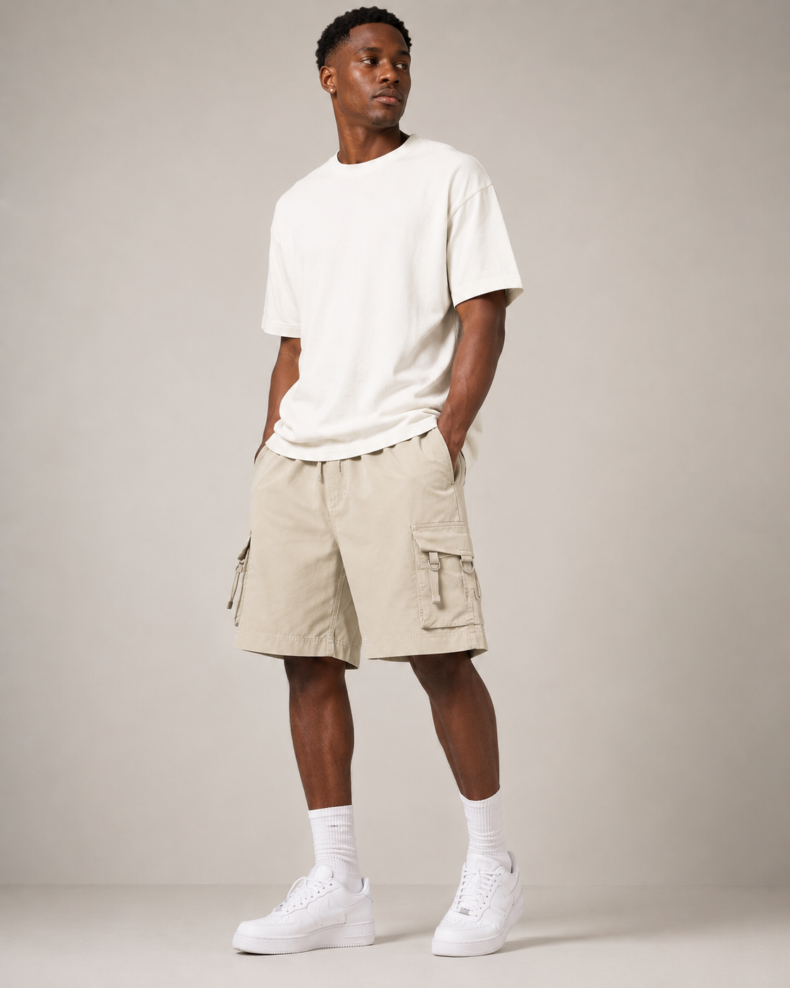 Beige Court Athletic Shorts styled on a male model, front view