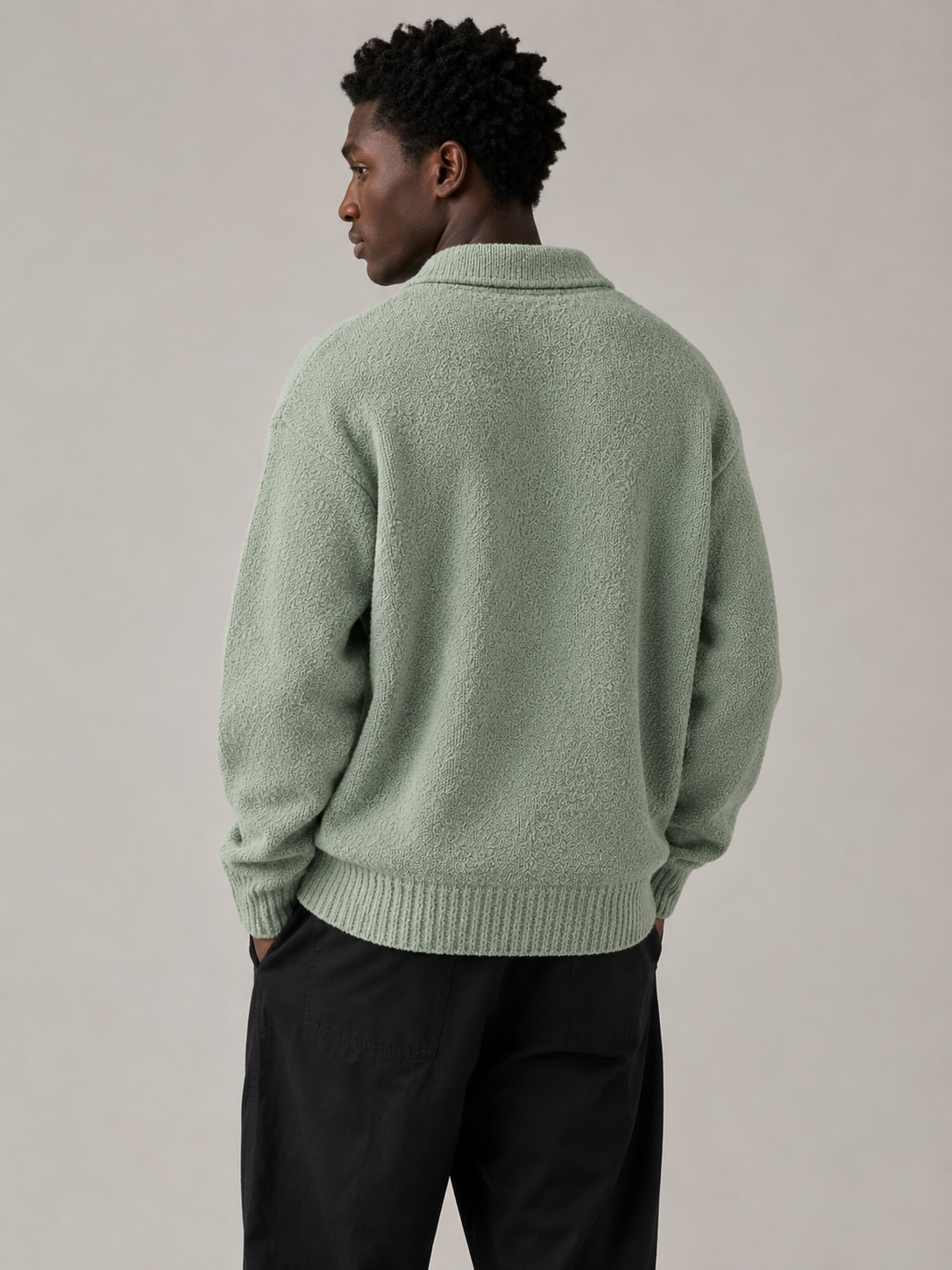 Professional Black male model wearing the Moss Knit Sweater — back view