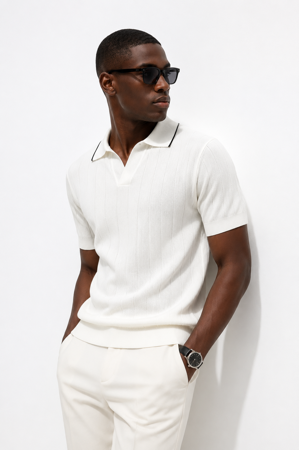 White ribbed knit polo styled on male model against white studio background